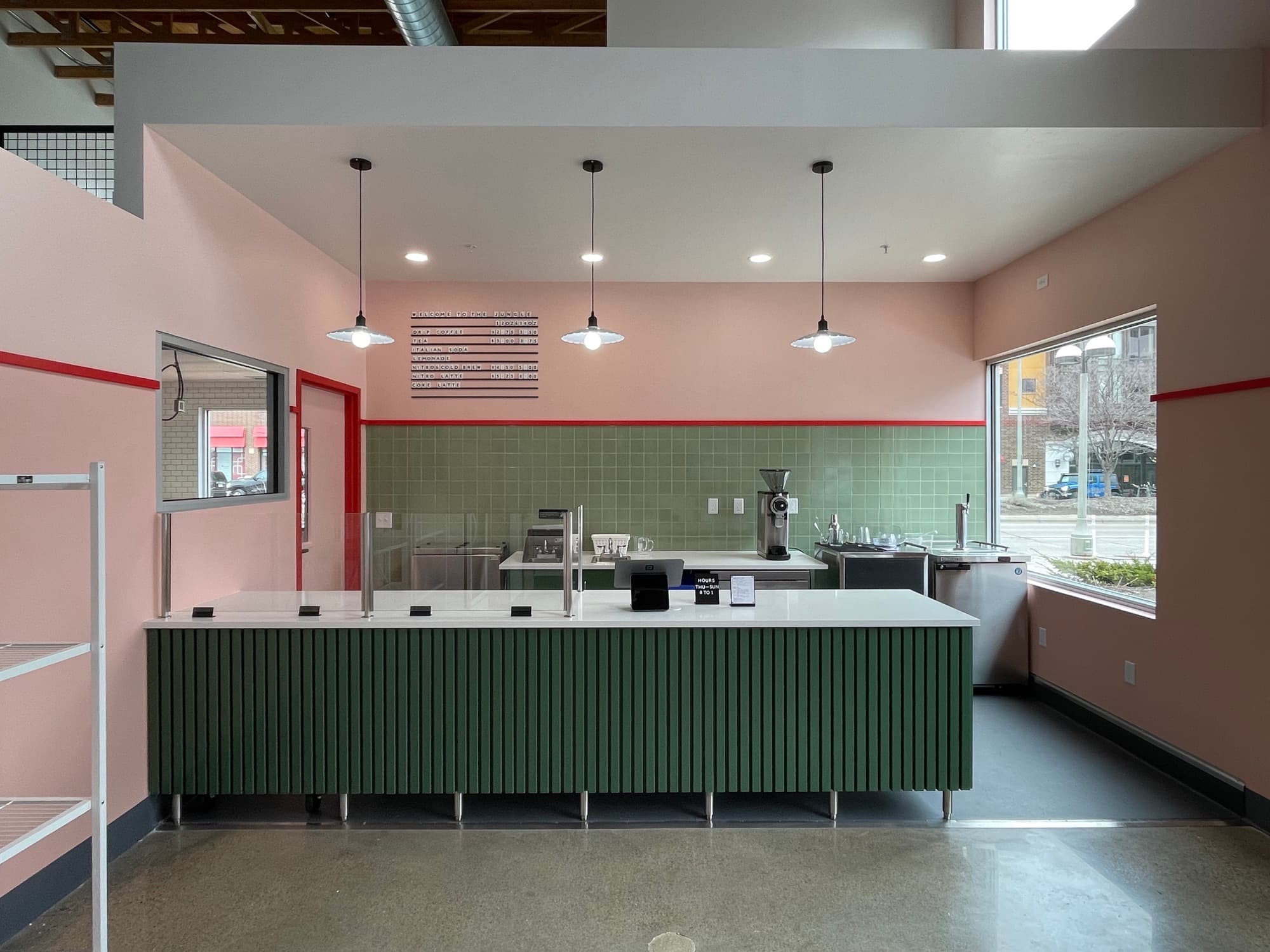 Shop counter with a green fluted base and pendant lights