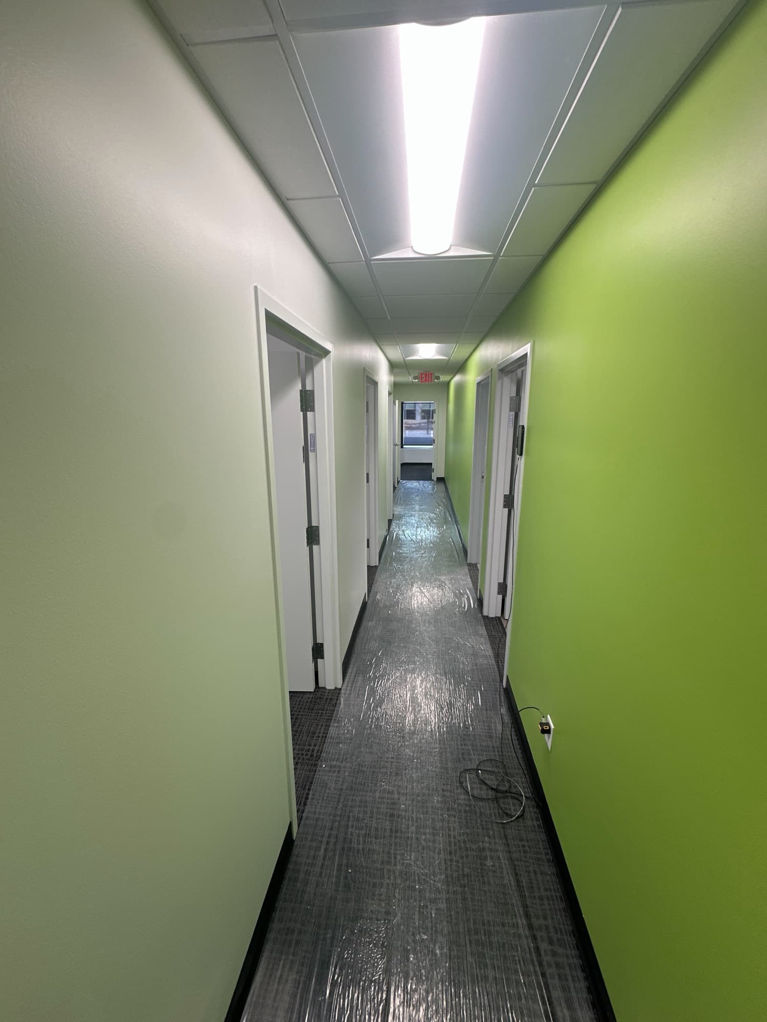 Long corridor with a lime green accent wall
