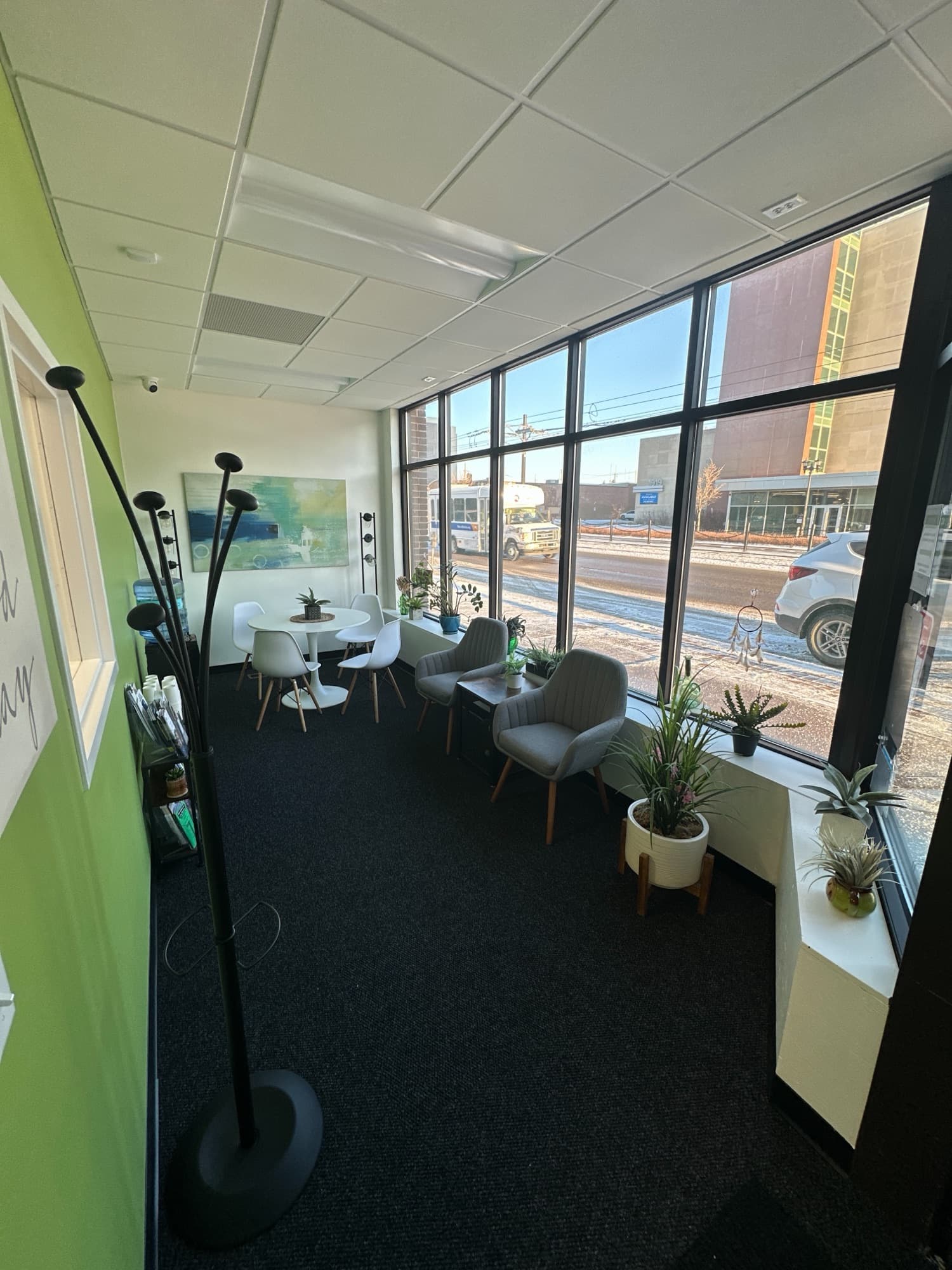 Seating area beside tall windows with a lime green wall